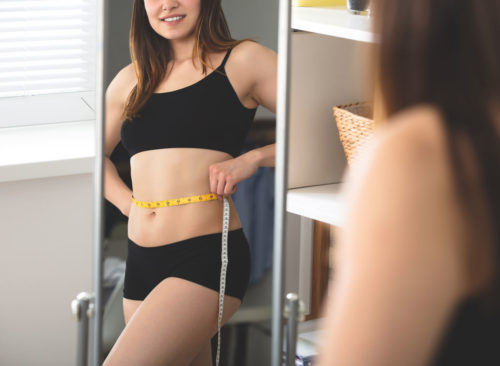 woman-belly-weight-loss-mirror-500x366